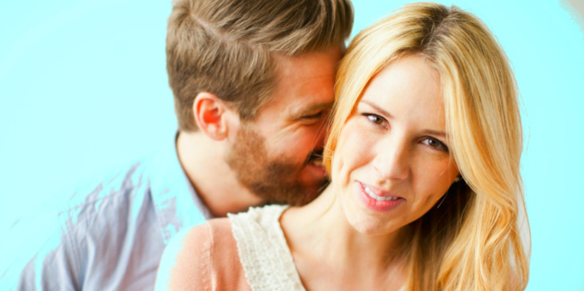 How To Use The 5 Love Languages To Rev Up Your Sex Life blonde couple against light blue background, he kisses her neck
