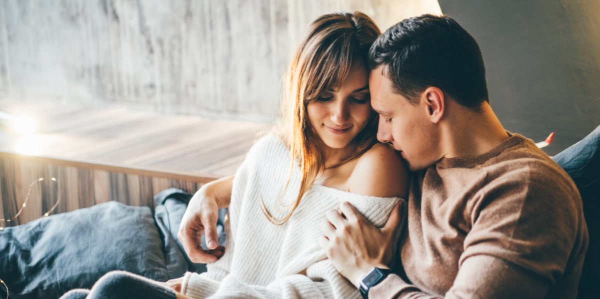 woman and man cuddling on the couch