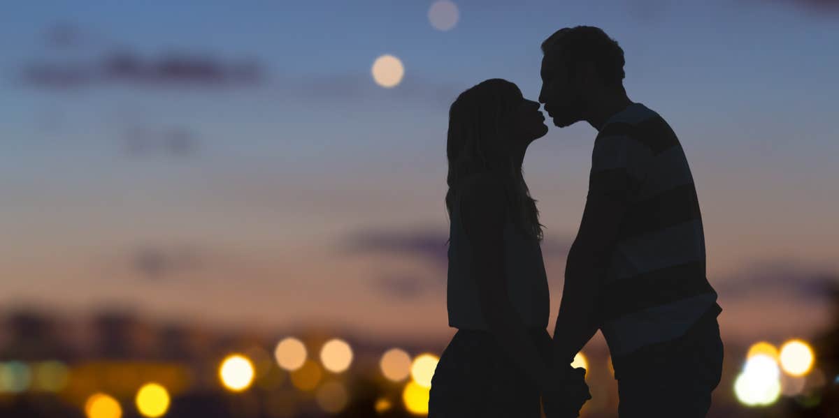 couple kissing at night