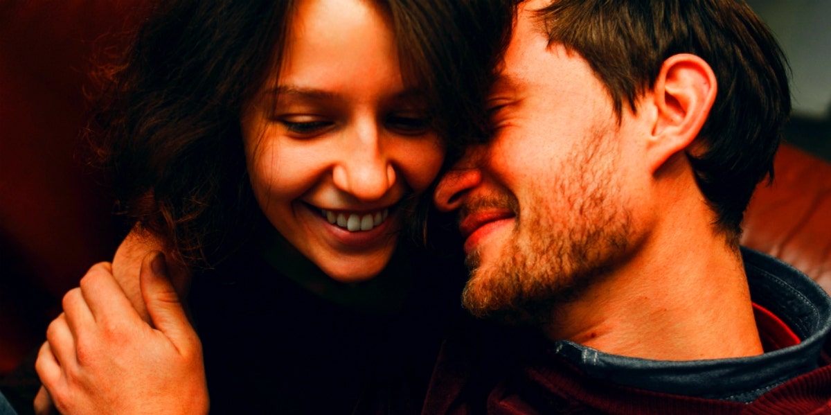 The Difference Between Loving Someone Vs. Being In Love couple cuddling