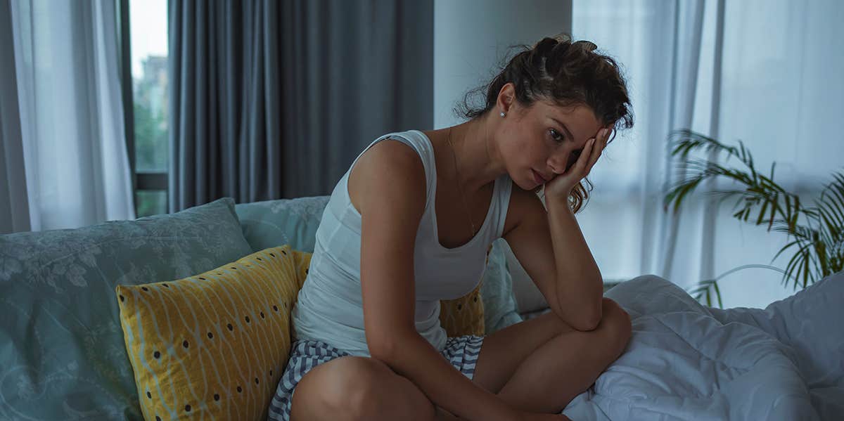 unhappy girl sitting on couch