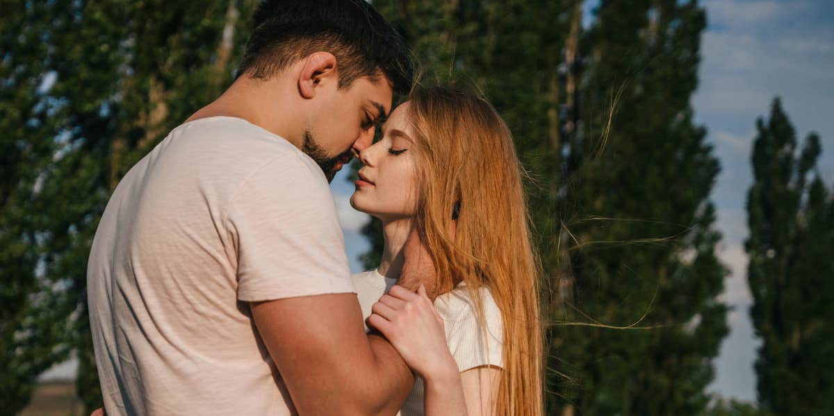 two people looking at each other hugging 