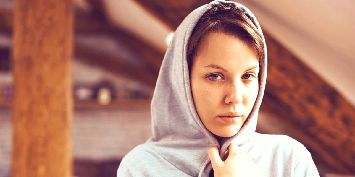 woman in hoodie with low self-esteem