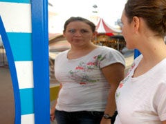 woman with poor body image looking in funhouse mirror