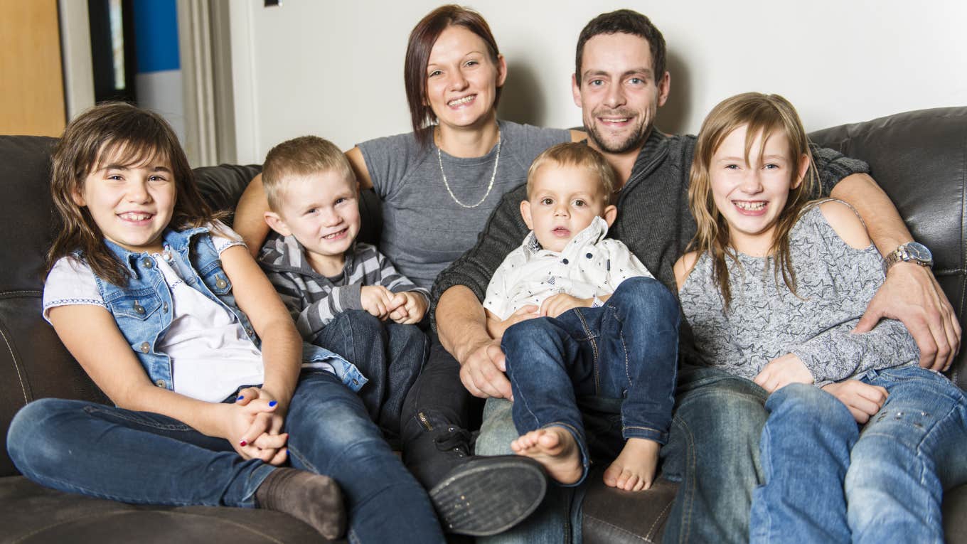 Large family smiling for a photo on a couch