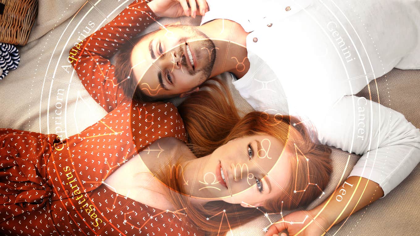 couple laying side by side looking into the camera
