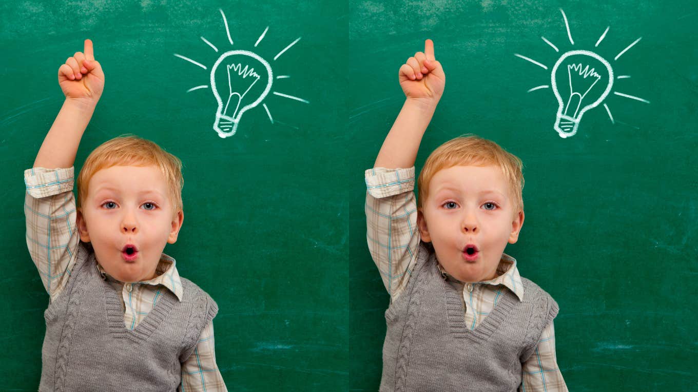 Cheerful smiling child at the blackboard