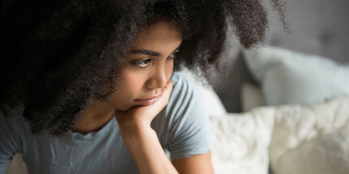 woman with hand on chin in contemplative mood