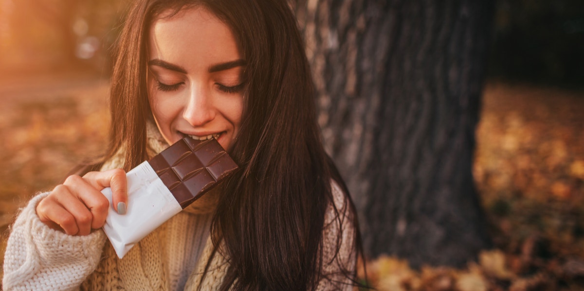 This Magical Chocolate Will Instantly Cure Your Period Cramps woman eating chocolate