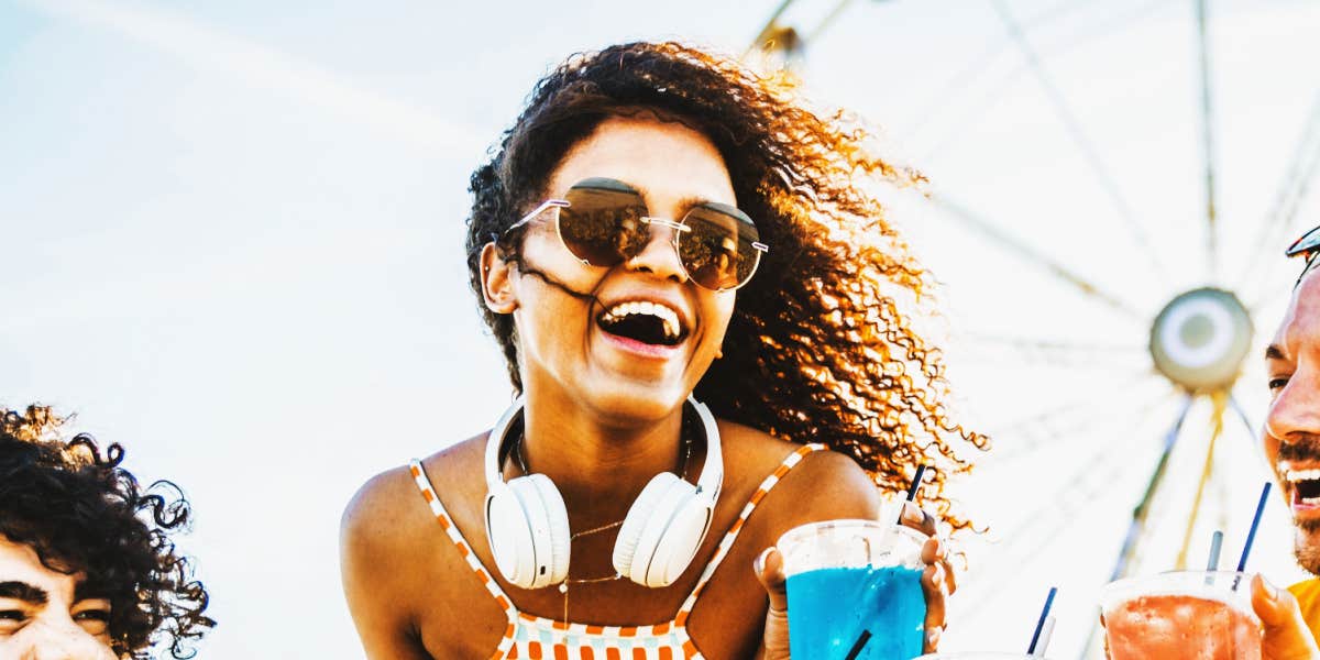 young woman laughing at an amusement park