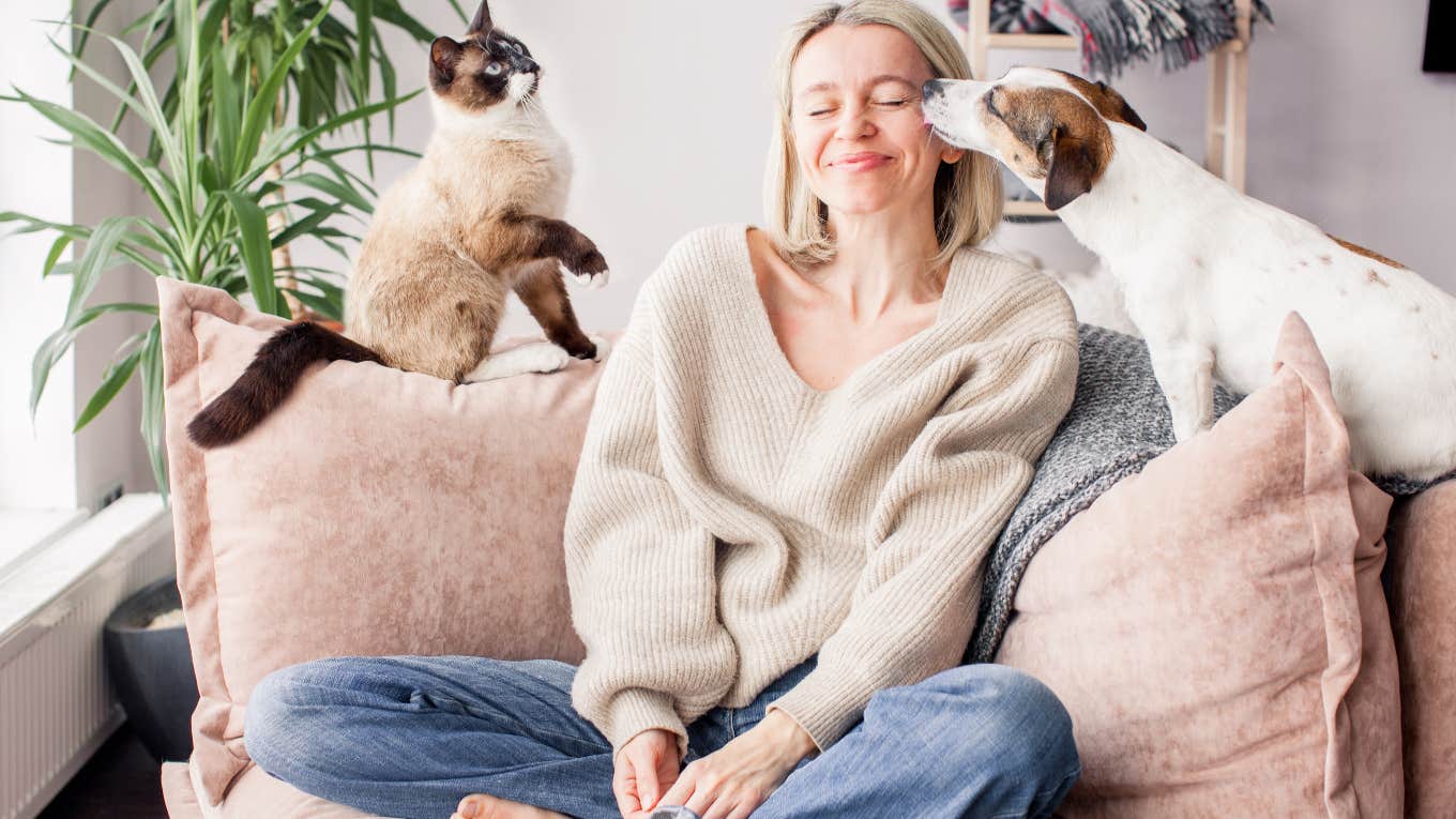 The Main Personality Difference Between Dog People And Cat People woman with a cat and dog