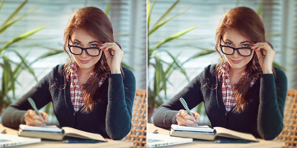 woman holding her glasses