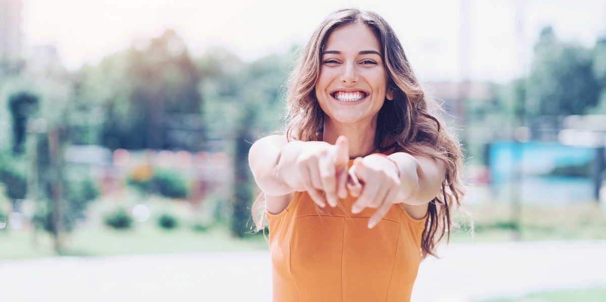 happy woman wearing an orange shirt