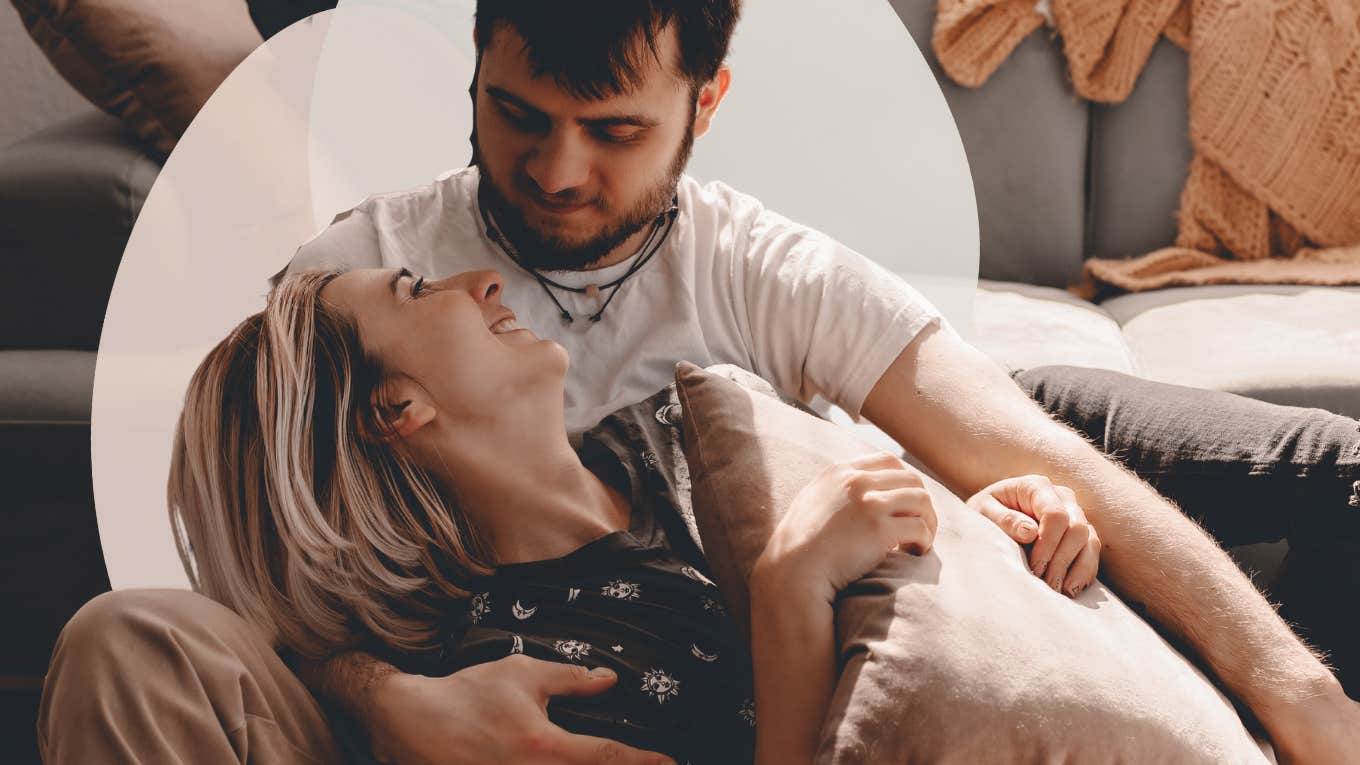 Couple on the floor, woman laying in his lap