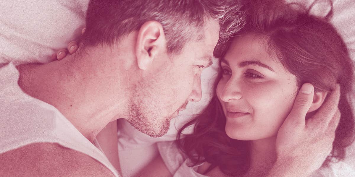 7 Steamy Ways To Boost Intimacy—With Food couple smiling on bed