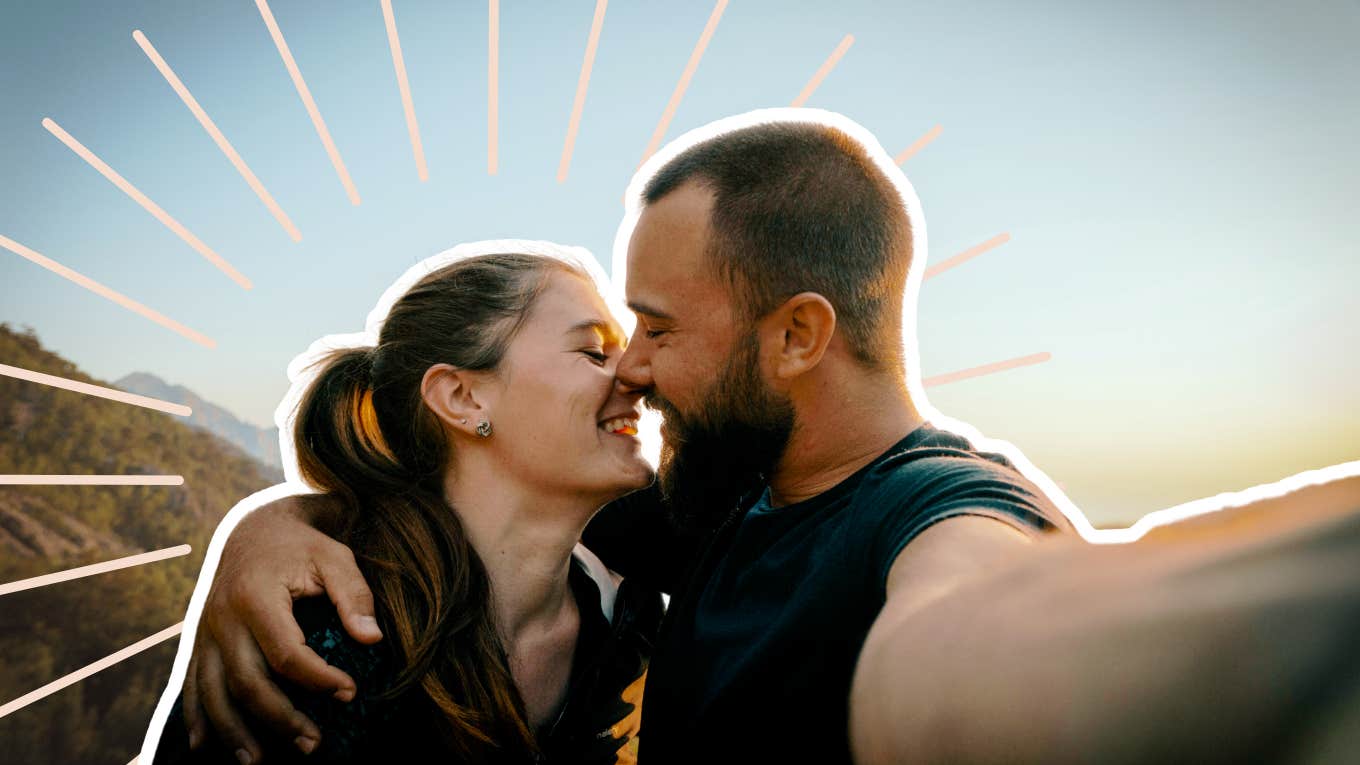 Couple hiking, taking a selfie kissing 