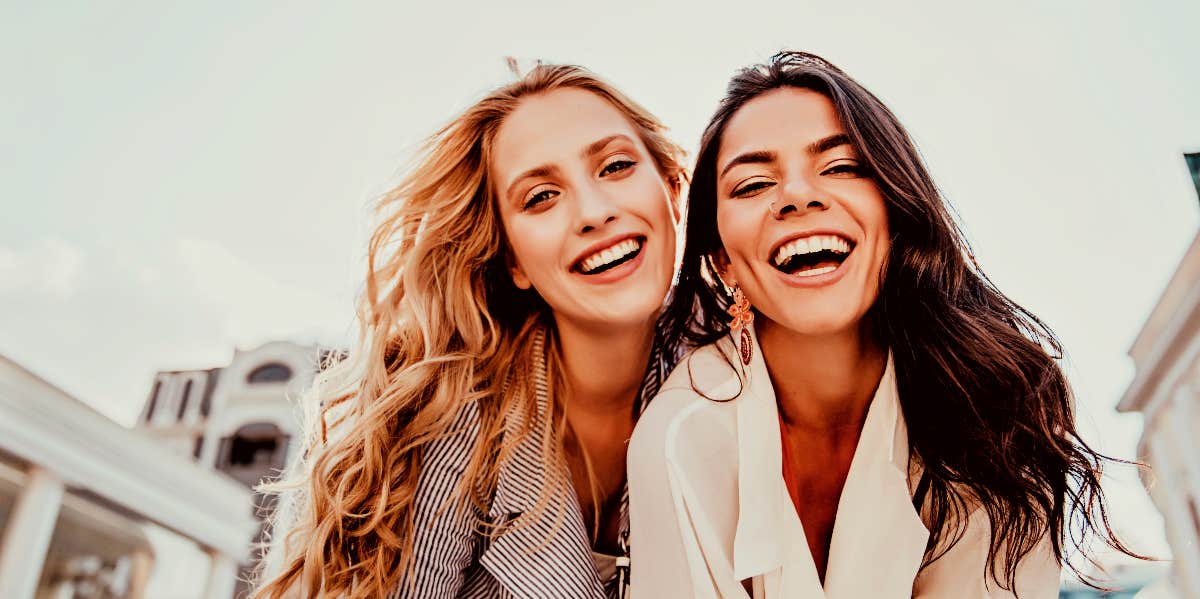 Two happy women looking at camera