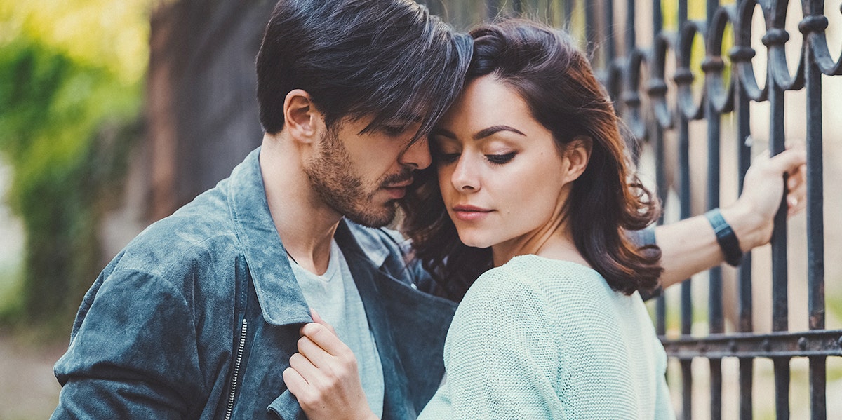 woman gripping man's jean jacket