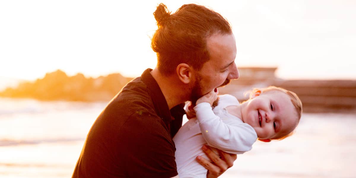 Man and baby playing on a beach