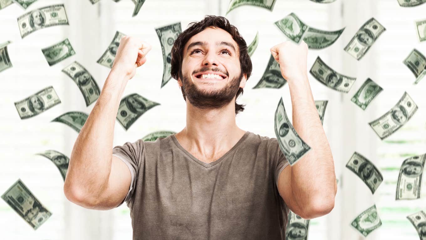 man standing in money floating through the air