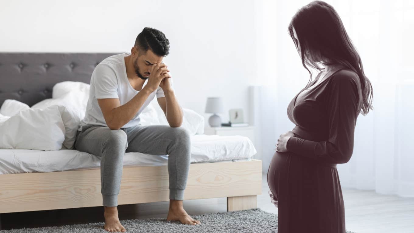man on bed next to pregnant woman