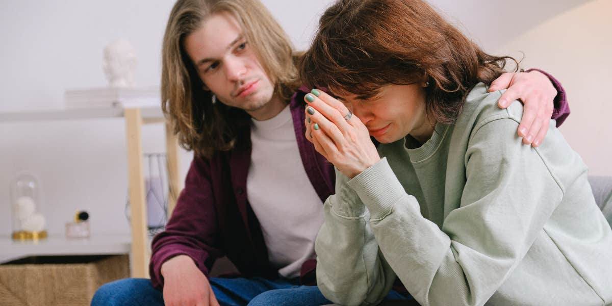 Man comforting woman