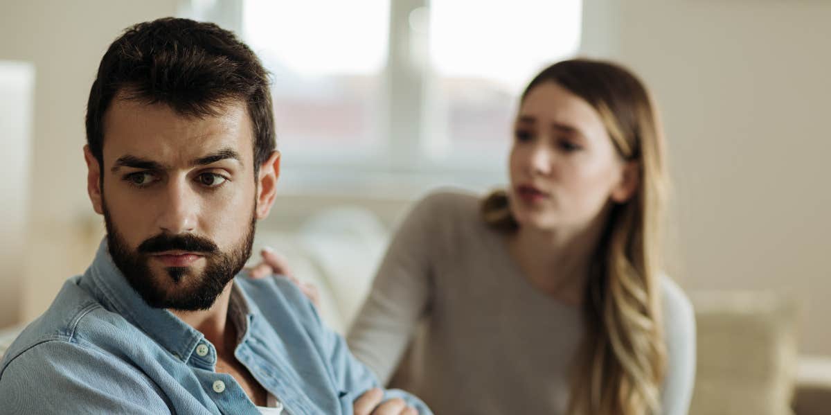 man and woman arguing on couch