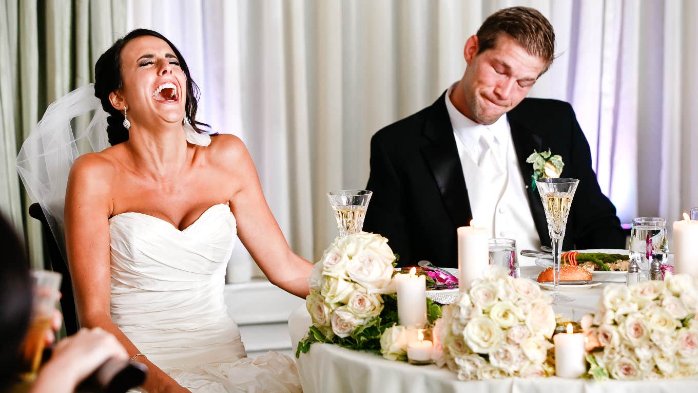bride and groom at sweetheart table during wedding