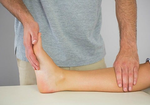 man examining leg