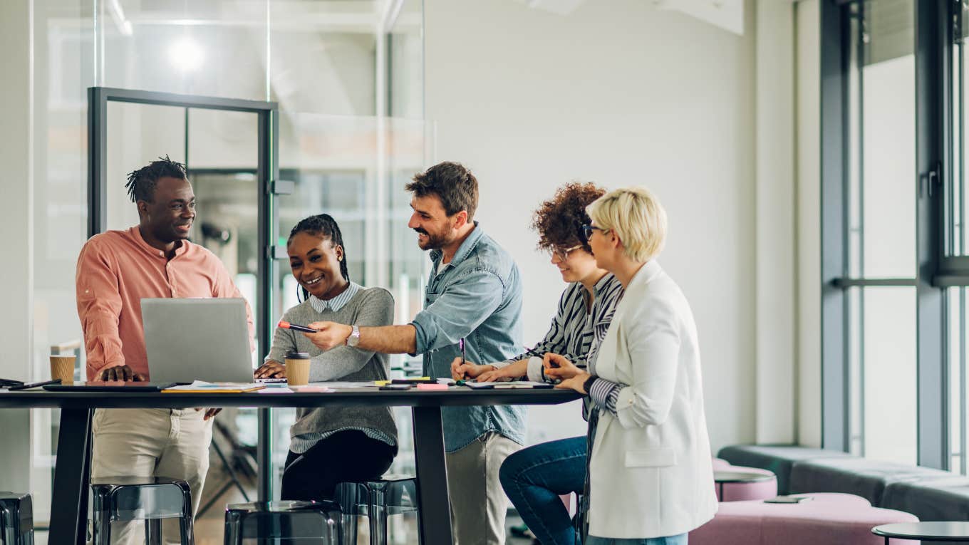 Man Explains How To Have A Month Of 4-Day Workweeks By Only Taking One Day Off employees gathered in the office having fun during brainstorming while discussing new ideas for their new project.