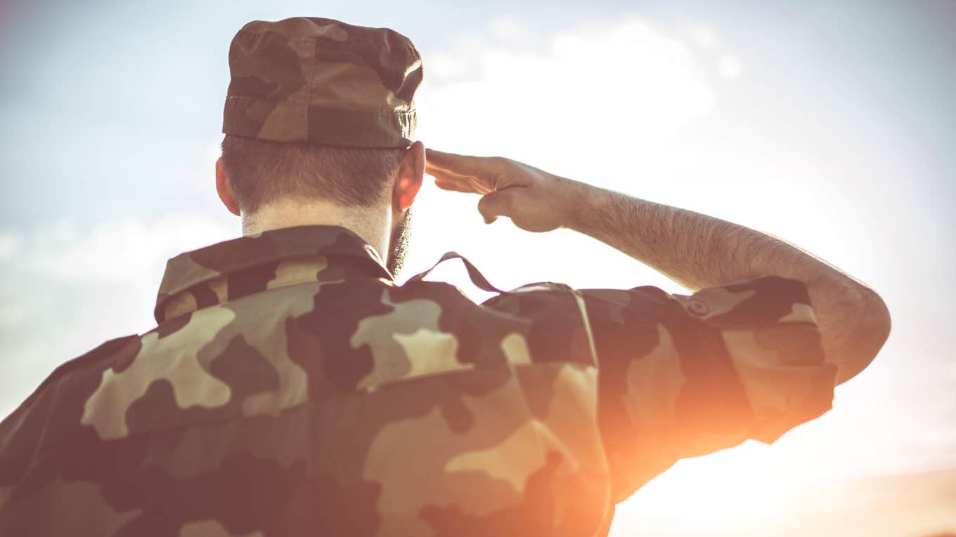 back view of army solider saluting
