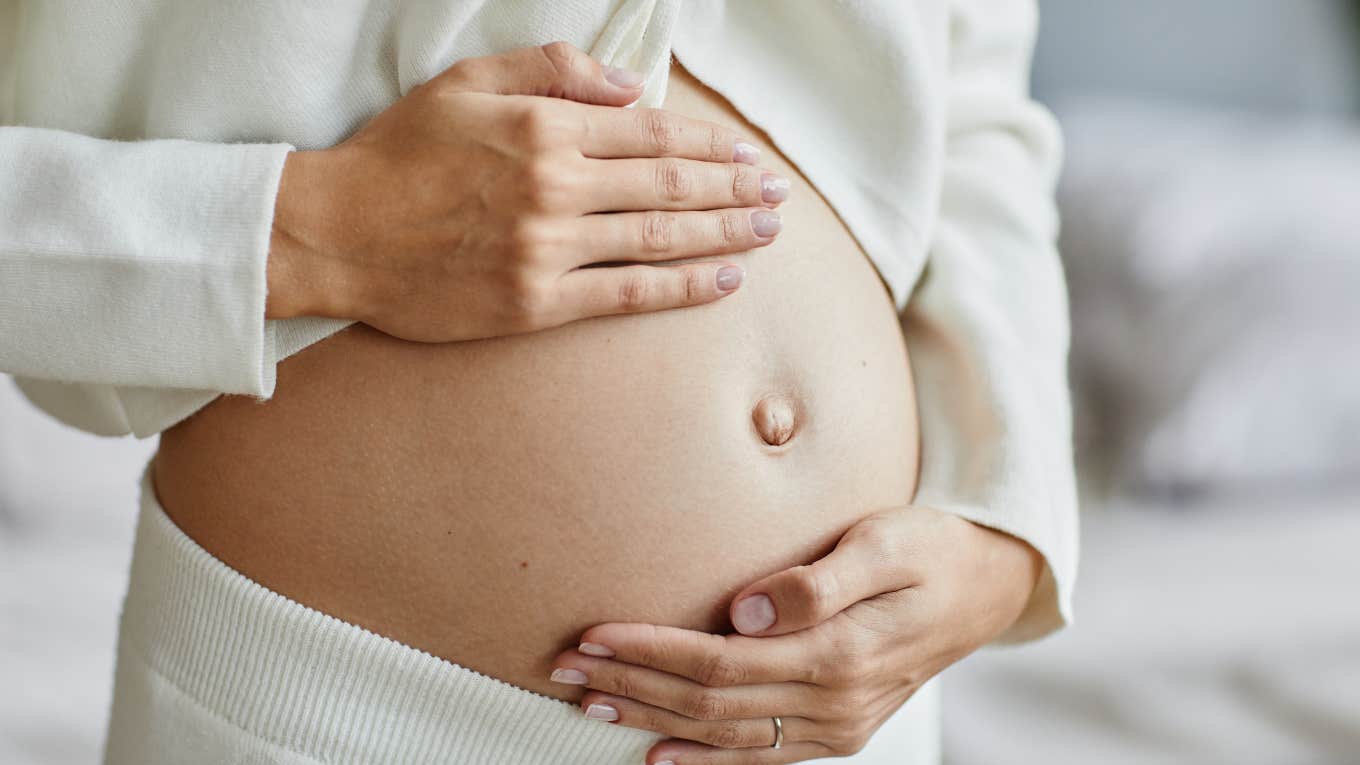 pregnant woman holding her belly