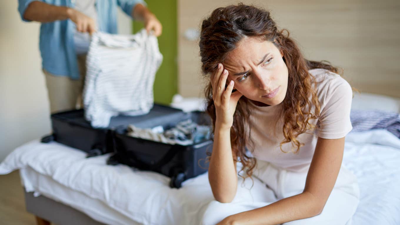 upset wife and husband packing his suitcase