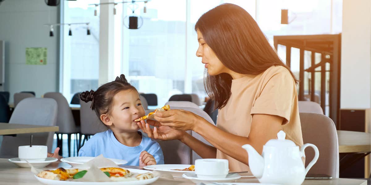 mom feeding child