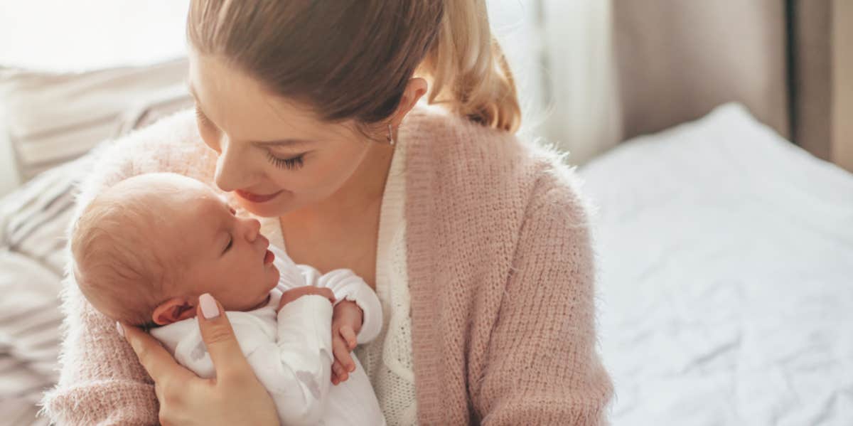 Woman holding newborn baby