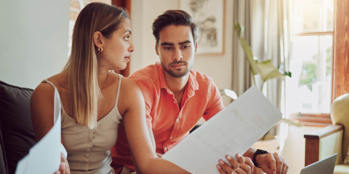 Woman looking at husband while paying bills