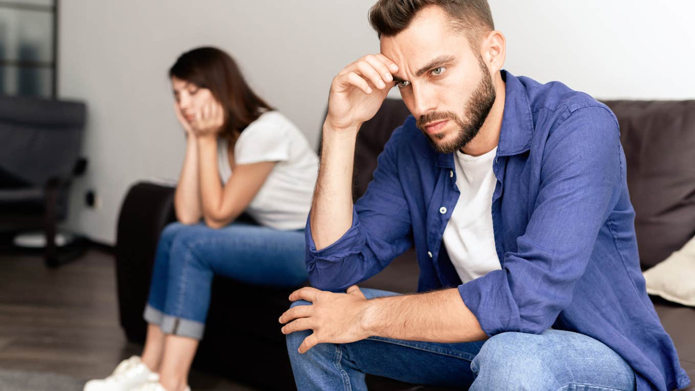 frustrated couple sitting apart from each other on couch