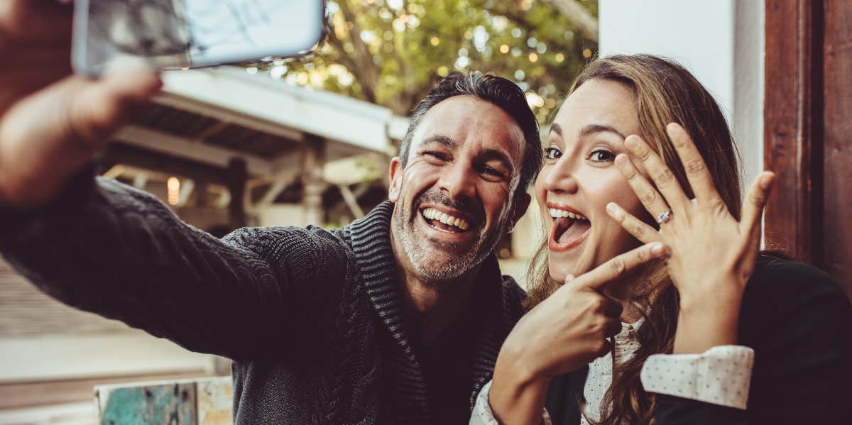 Engaged couple taking a picture