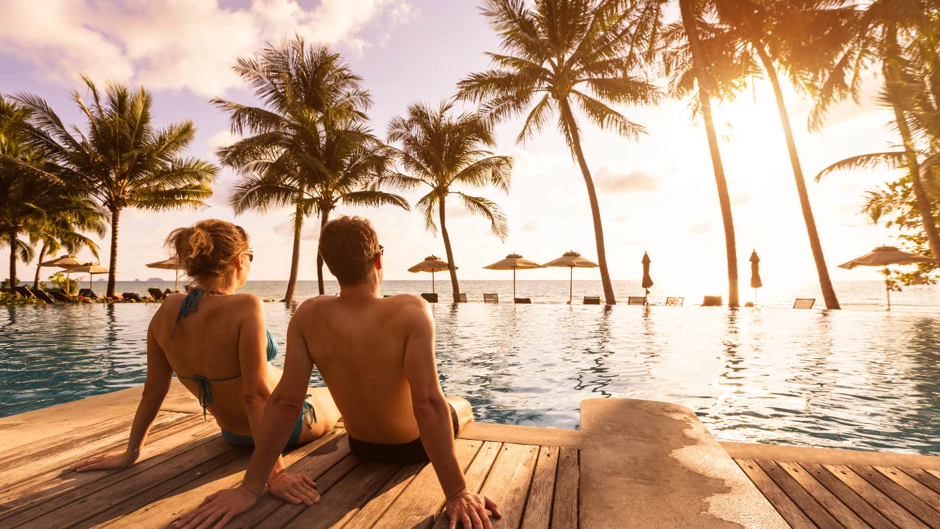 couple sitting on the beach at an all-inclusive resort