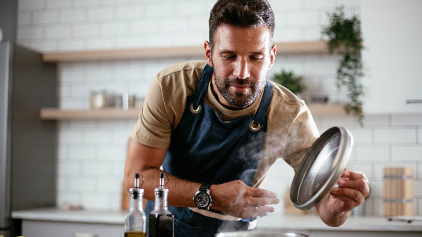 man cooking in kitchen with apron on