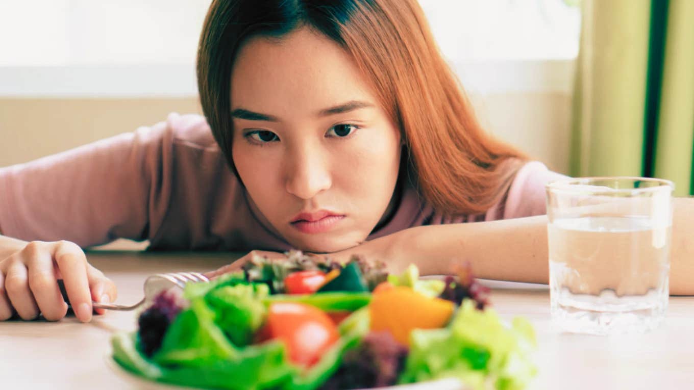 Man Tells His Daughter That If She Wants To Be Vegan She'll Need To Get A Job To Pay For Her Own Groceries daughter looking at vegan meal on table