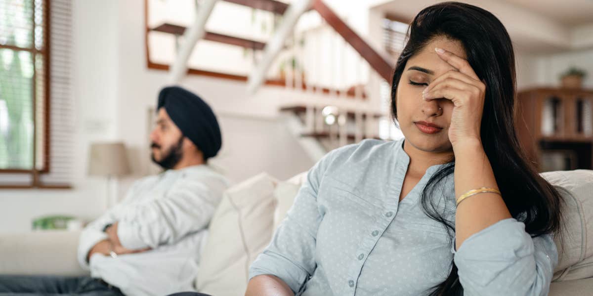 Upset couple sitting on couch after argument