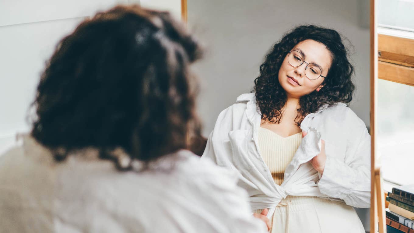 plus-size woman looking into the mirror