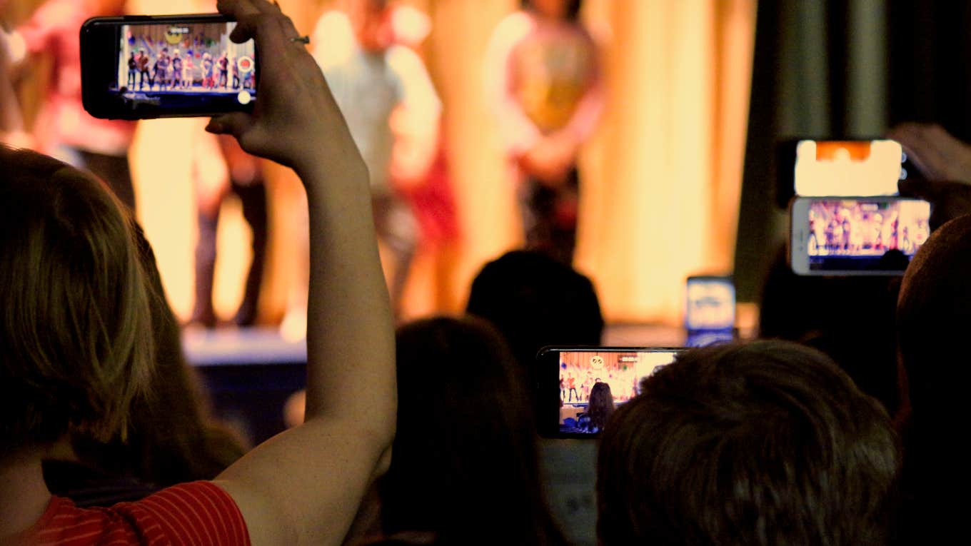 Man Encourages Parents to Go to School Performances parents filming children on stage