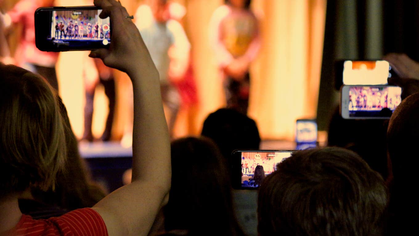 parents filming children on stage