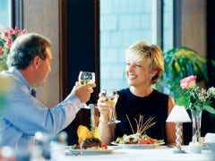 man woman toasting dinner friends