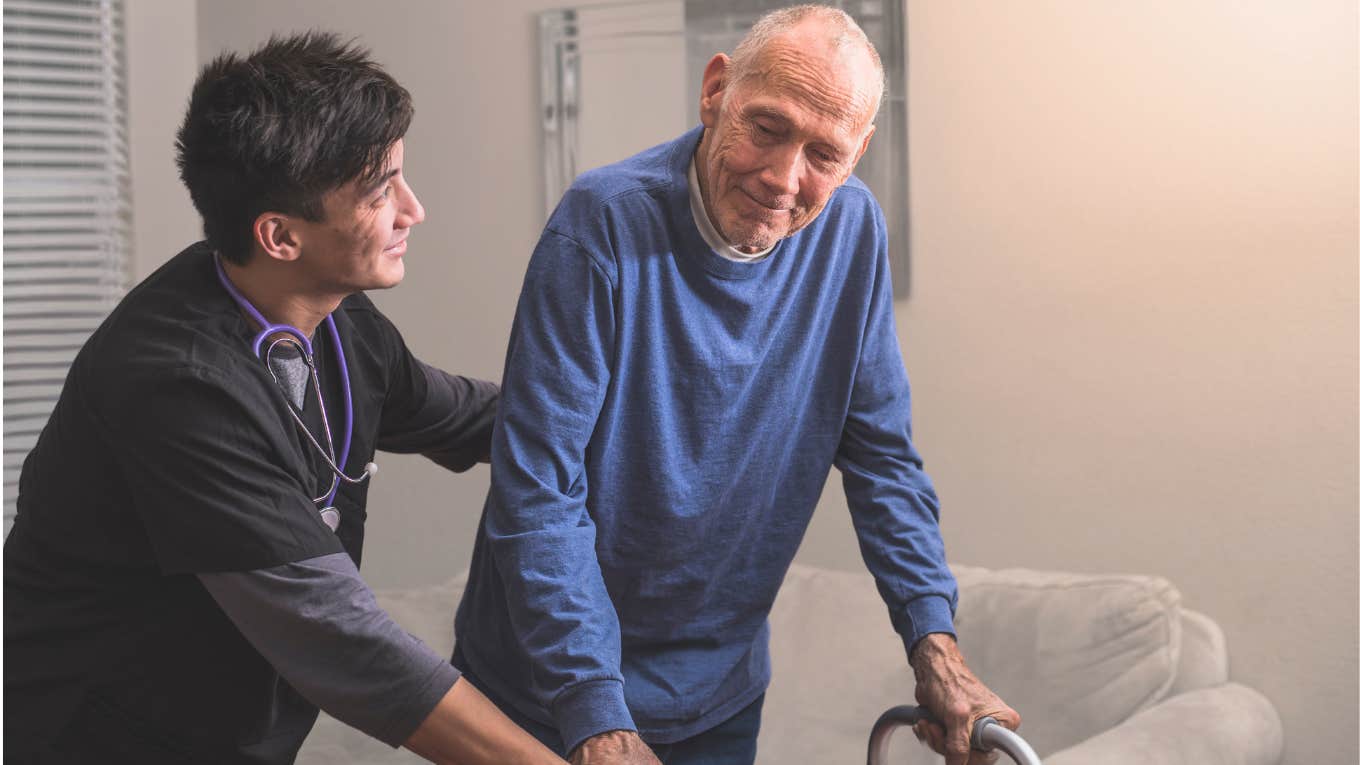 Nurse helps an elderly sick man with a walker. 