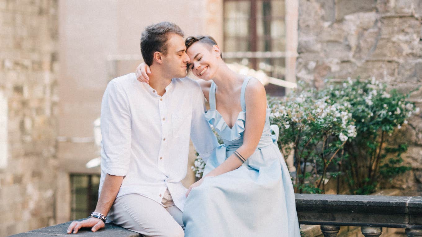 a man and a woman embracing happily