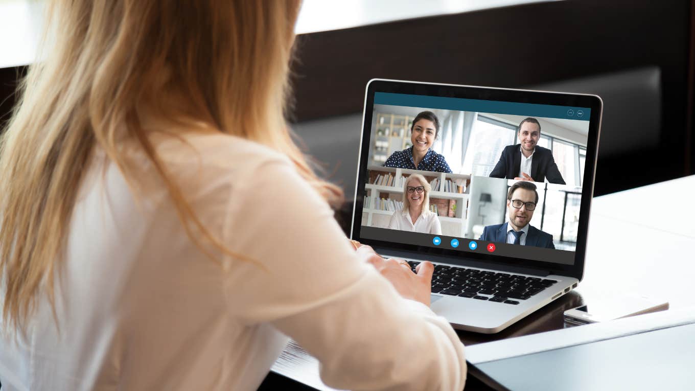Manager Instructed To Tell Remote Employee To Stop Having Her Baby On Work Calls Back view of businesswoman speak using Webcam conference on laptop with diverse colleagues