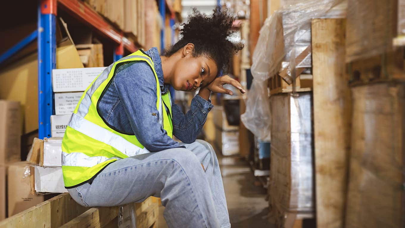 tired stressed woman sitting at her labor job